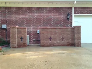 Brick screen wall with brick columns in front of a home