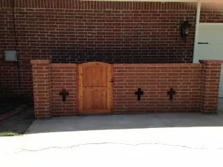 Brick screen wall with a wood gate