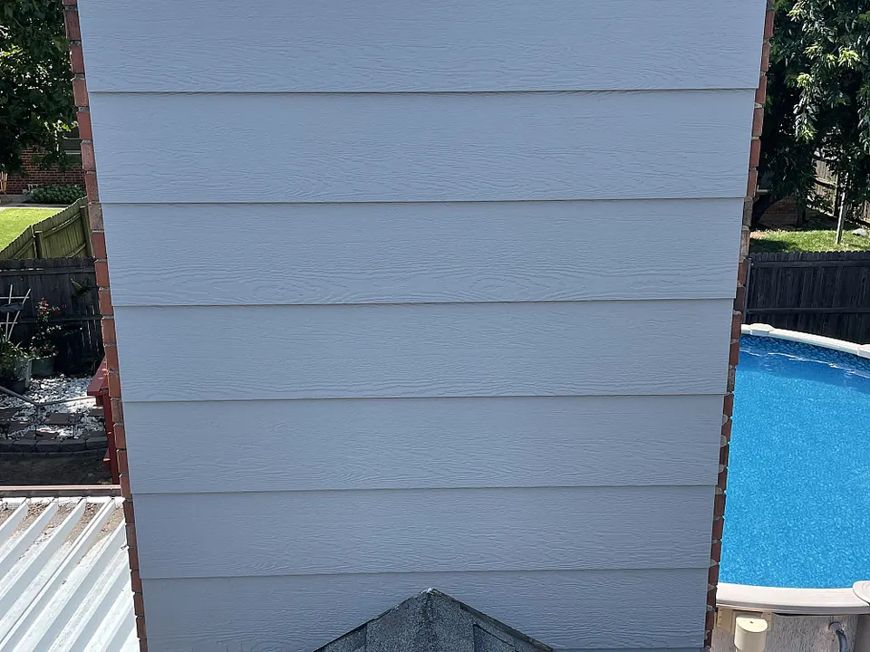 Chimney chase with new siding above the roofline