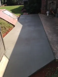 Finished concrete sidewalk beside a lawn
