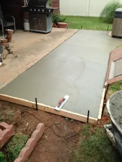 Fresh concrete sidewalk inside wood forms