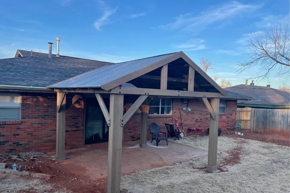 Covered porch with a pitched metal roof built by Jim Cox, JRI Services of Oklahoma City