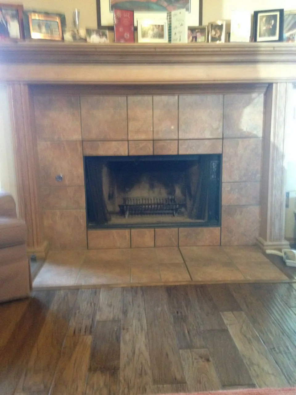 Tiled fireplace surround and hearth with a wood mantel